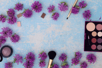 Makeup blusher rouge and brushes with violet bergamot flower