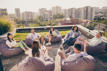 Photo of group students sitting bean bags having rest discussing lectures workplace workshop urban...
