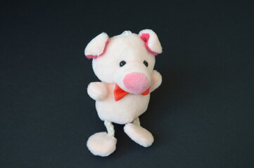 soft toy, pink pig on a black background
