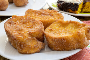 detail of baked or fried bread with sugar and cinnamon. Dessert called Rabanada, Torrija or golden bread. cuisine from Brazil, Portugal and Spain. Breakfast table.