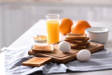 Delicious breakfast with toasts on table in kitchen