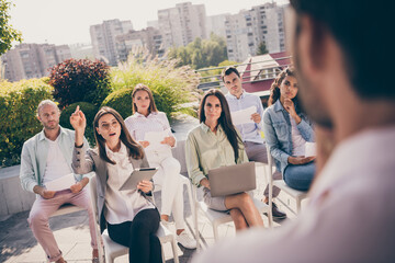 Fototapeta premium Photo of group of people listen boss leader businessman outside outdoor serious woman in glasses raise hand asking question