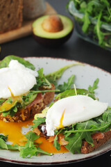 Homemade sandwiches with salmon, avocado and poached eggs