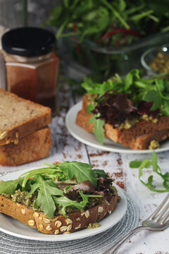 Homemade Sandwiches With Pesto, Green Salad And Poached Eggs