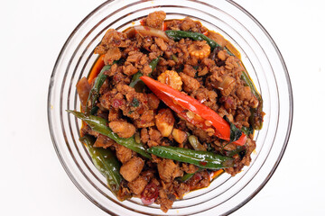 Stair fried Thai basil minced chicken spicy red green chili in glass serving bowl on white background
