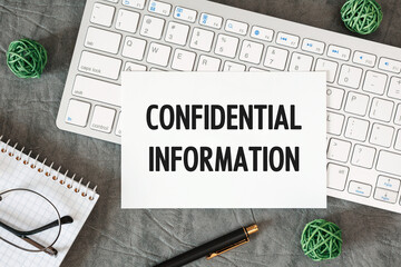 Confidential Information is written in a document on the office desk