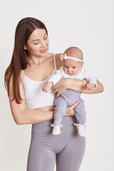 Loving young European mother hold little newborn infant child, enjoying moment together, caring mom embrace small baby toddler, maternity, childcare, isolated over white background.