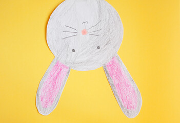 funny paper easter bunny on a yellow background.
