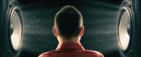 A man listens to powerful sound from the speakers.