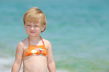 Beautiful little girl playing in the sea