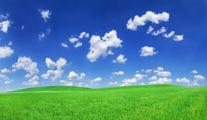 Idyllic view, green hills and blue sky with white clouds