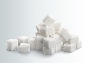 White cubes of sugar on a bokeh background