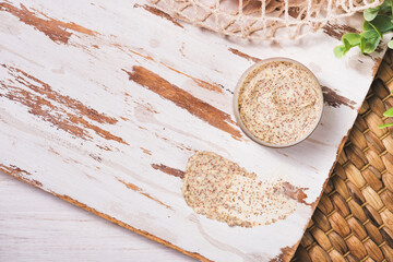 Natural body scrub on marble background. Cosmetic face cream container with care cruelty-free product. Flat lay, top view