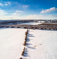 View of the snow-covered skyline of Duisburg on a sunny winter day from above