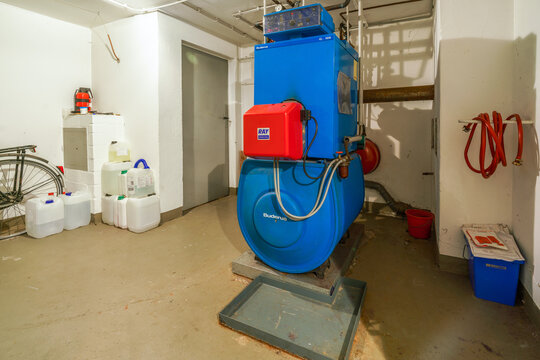 Old blue Buderus G 105 heating boiler with red Ray oil burner