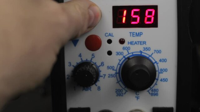 air temperature adjustment of a hot air gun at a soldering station, close-up 