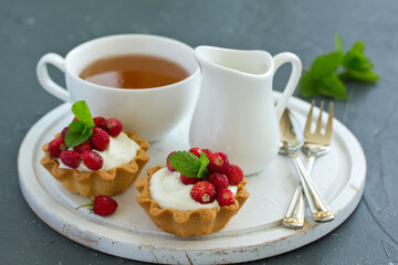 Wild strawberry tartlets with cream filling. delicious summer fruit mini tarts