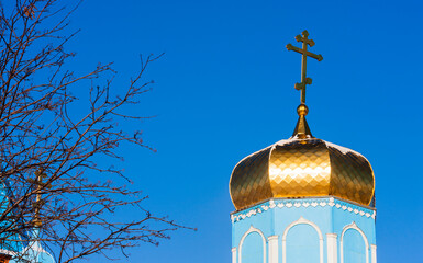 Dome of a rural Orthodox cathedral with a cross. Selective focus.