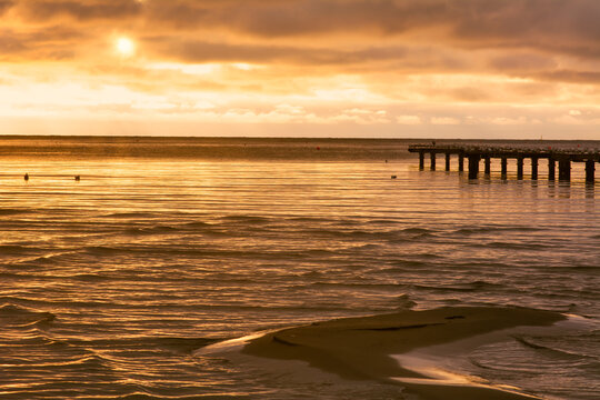 A sand bar with a beautiful ocean sunset in the background. Photo from Hallevik, Blekinge county, Sweden