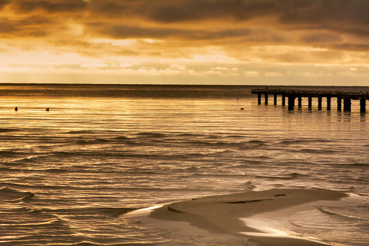 A sand bar with a beautiful ocean sunset in the background. Photo from Hallevik, Blekinge county, Sweden