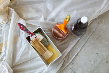 Paint Brush in the Plastic Jar contained Lacquer Prepared for Wooden Door Lacquering.