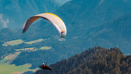 Beautiful alpine summer view with a paraglider at the famous Hochfelln summit, Bergen, Bavaria, Germany