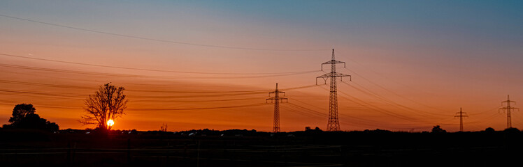 Beautiful summer sunset with high voltage overhead lines near Aholming, Bavaria, Germany