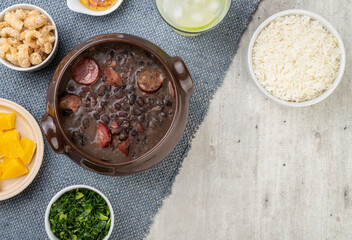 Traditional brazilian feijoada with rice, kale, caipirinha and copy space