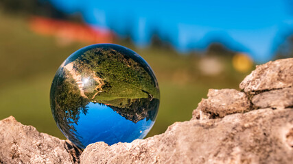 Crystal ball alpine summer landscape shot at the famous Hochfelln summit, Bergen, Bavaria, Germany