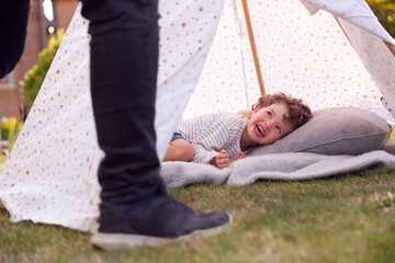 Close Up Of Father And Son Having Fun With Tent Or Tepee Pitched In Garden © Monkey Business
