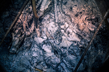 Remains of coal and ashes after the combustion of firewood burned