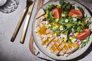 Grilled chicken breast with tomatoes and green salad with mango dressing