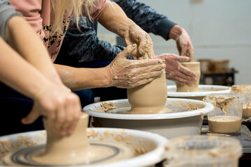 Master class on modeling of clay on a potter's wheel In the pottery workshop - Powered by Adobe