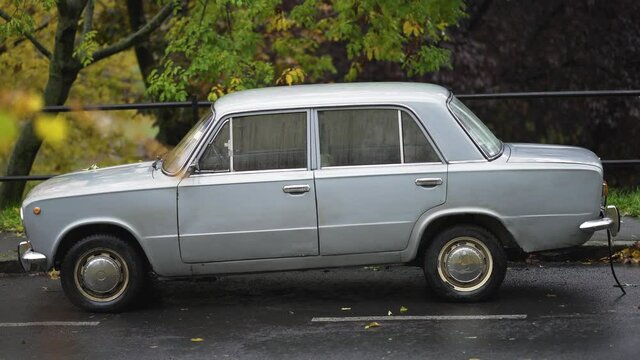 Lada 2101, socialist retro car parking on the street.