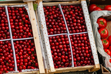 Wooden box with fresh ripe cherries.