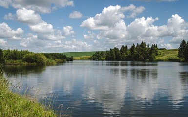 Fototapeta na wymiar Calm landscape of lake with clouds, rural landscape
