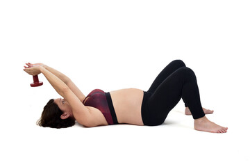 Fototapeta na wymiar pregnant woman exercising on the floor with dumbbell on white background
