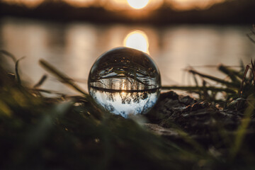 crystal ball on wood next to a river