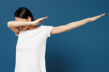 Young brunette student woman 20s wearing white casual basic t-shirt doing dab hip hop dance hands...
