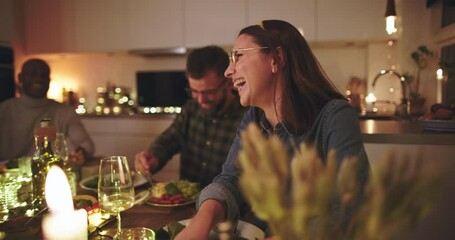 Woman laughing during
a dinner party