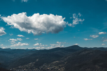 Fototapeta premium Summer landscape in mountains and the dark blue sky with clouds