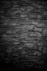Textur aus Stein oder Steinmauer als Hintergrundbild dunkel
