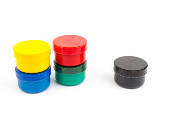 Plastic jars with paint of different colors for children's creativity on white background. Paint...