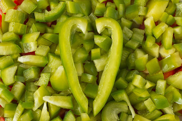 Close-up of pieces of sliced green bell pepper, top view. Healthy living concept.