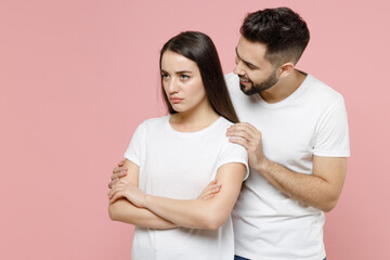 Young irritated offended sad couple two friends man woman in white basic t-shirts pout sulk sorry...