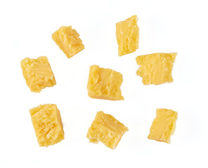 broken pieces of hard cheese isolated on white background