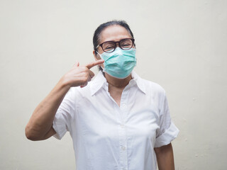 Old woman wearing medical mask