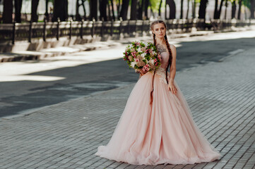 Fototapeta premium Portrait of a happy beautiful long-haired bride with two braids.