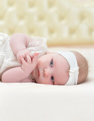 cute little girl is lying on the bed