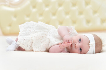 cute little girl is lying on the bed